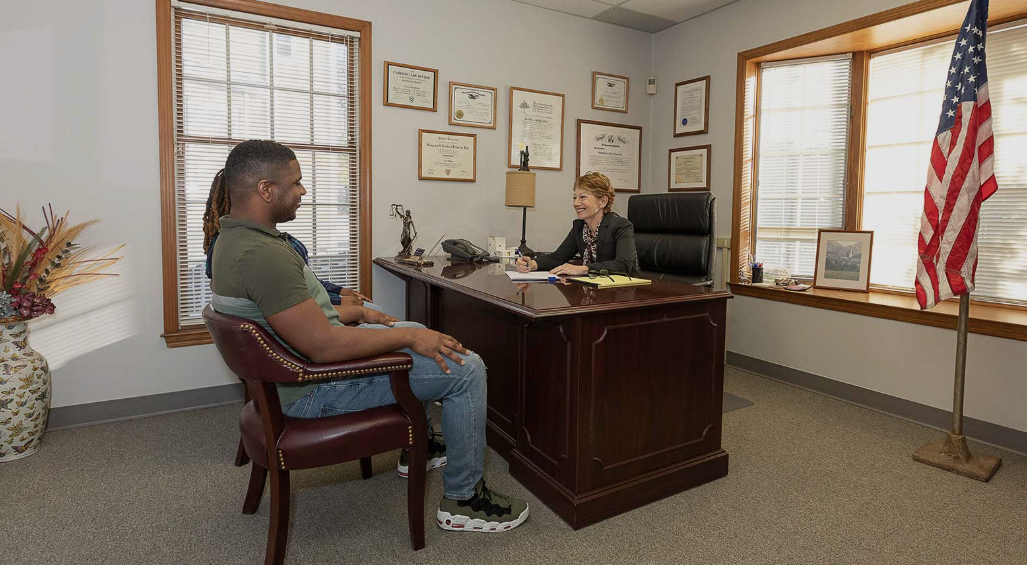 Law firm professional reviewing billing invoices at desk